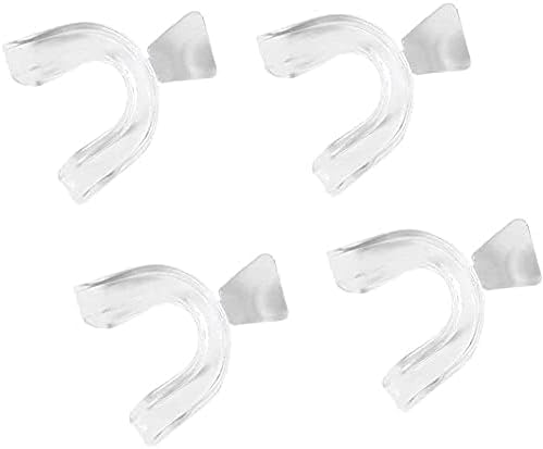 Set of four transparent silicone mouth guards laid out