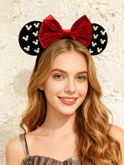 A Miaow velvet headband with pearls adds elegant sparkle for photos.