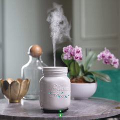 Airome Mason Jar diffuser emitting mist in a room
