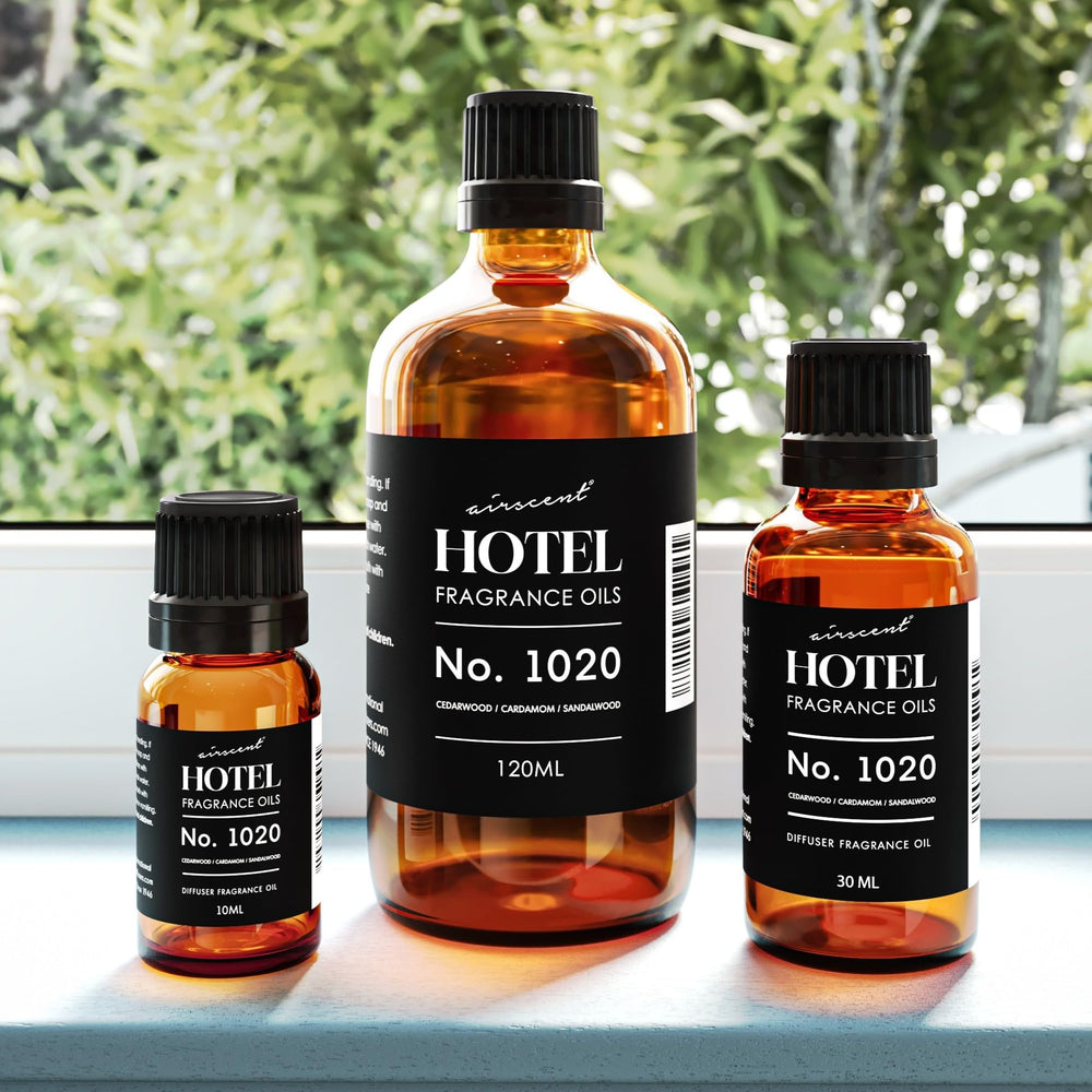Bottled diffuser oil 1020 Bergamot Cardamom Sandalwood on glass surface