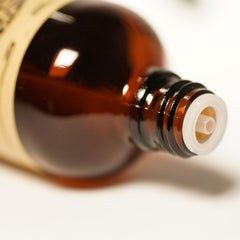 Dark amber glass bottle of AKARZ Perilla oil