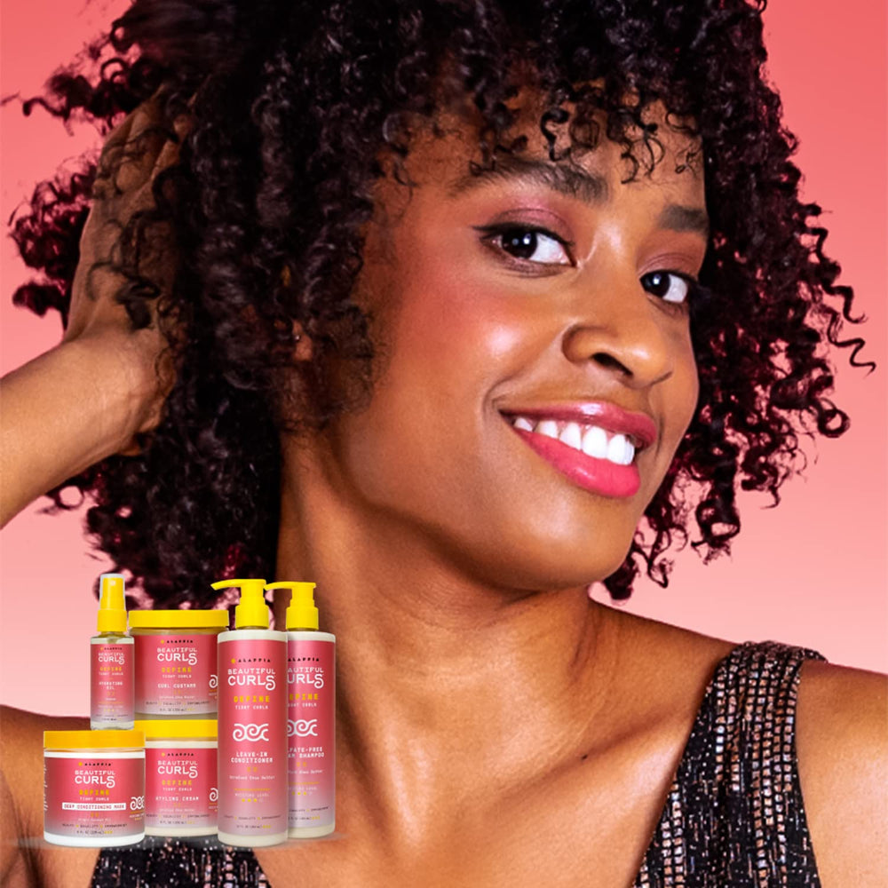 Hands applying Alaffia Beautiful Curls Shampoo to wet hair