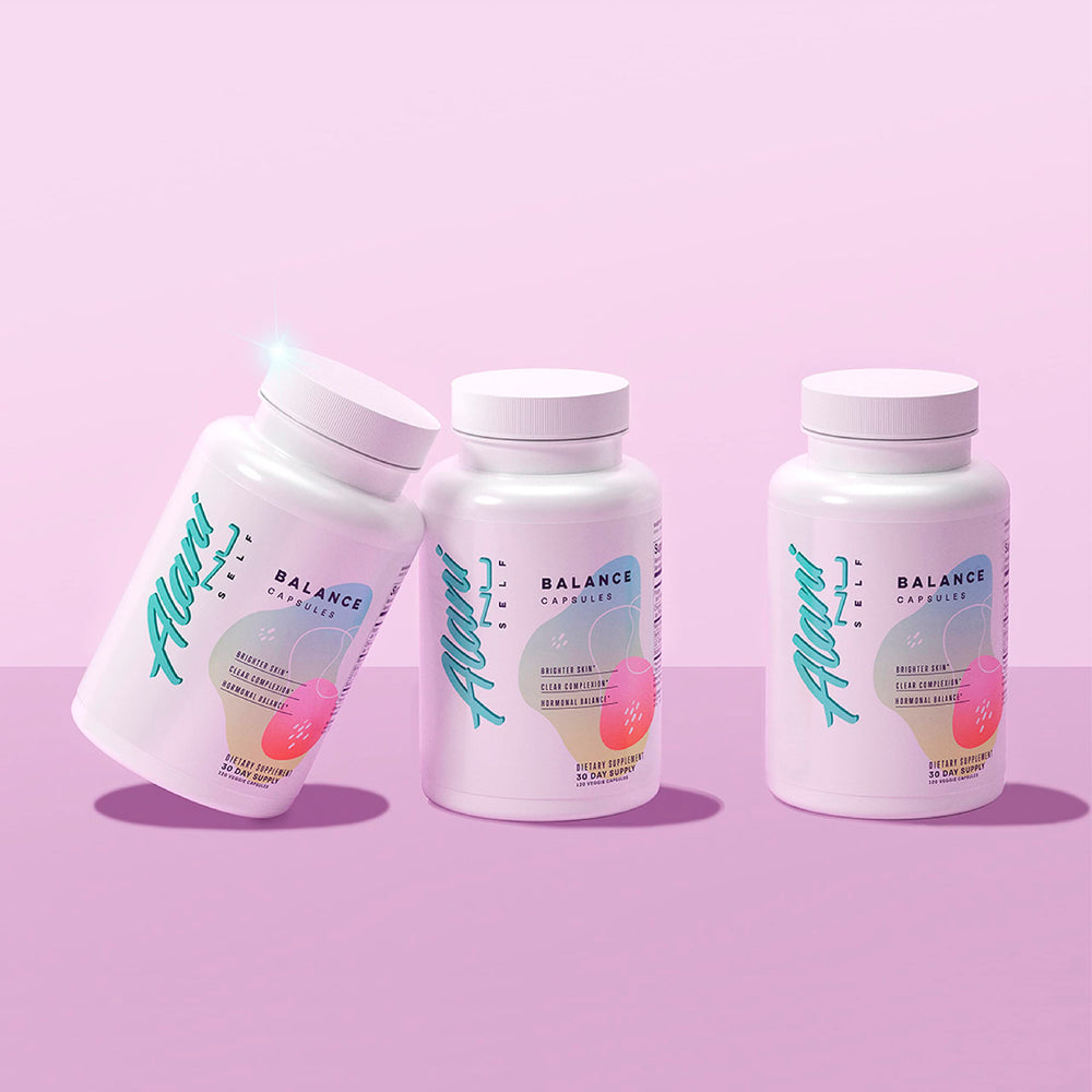 Alani Nu daily capsules beside glass of water during morning routine.