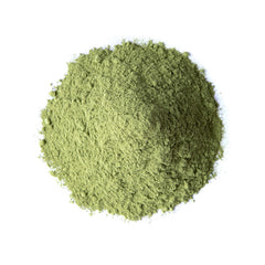 Alfalfa powder being added to a smoothie