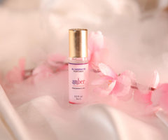 Amber Perfume Oil Roll-On bottle beside its packaging