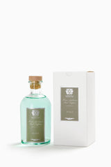 Close-up of Antica Farmacista Acqua reed diffuser in a glass bottle with reeds