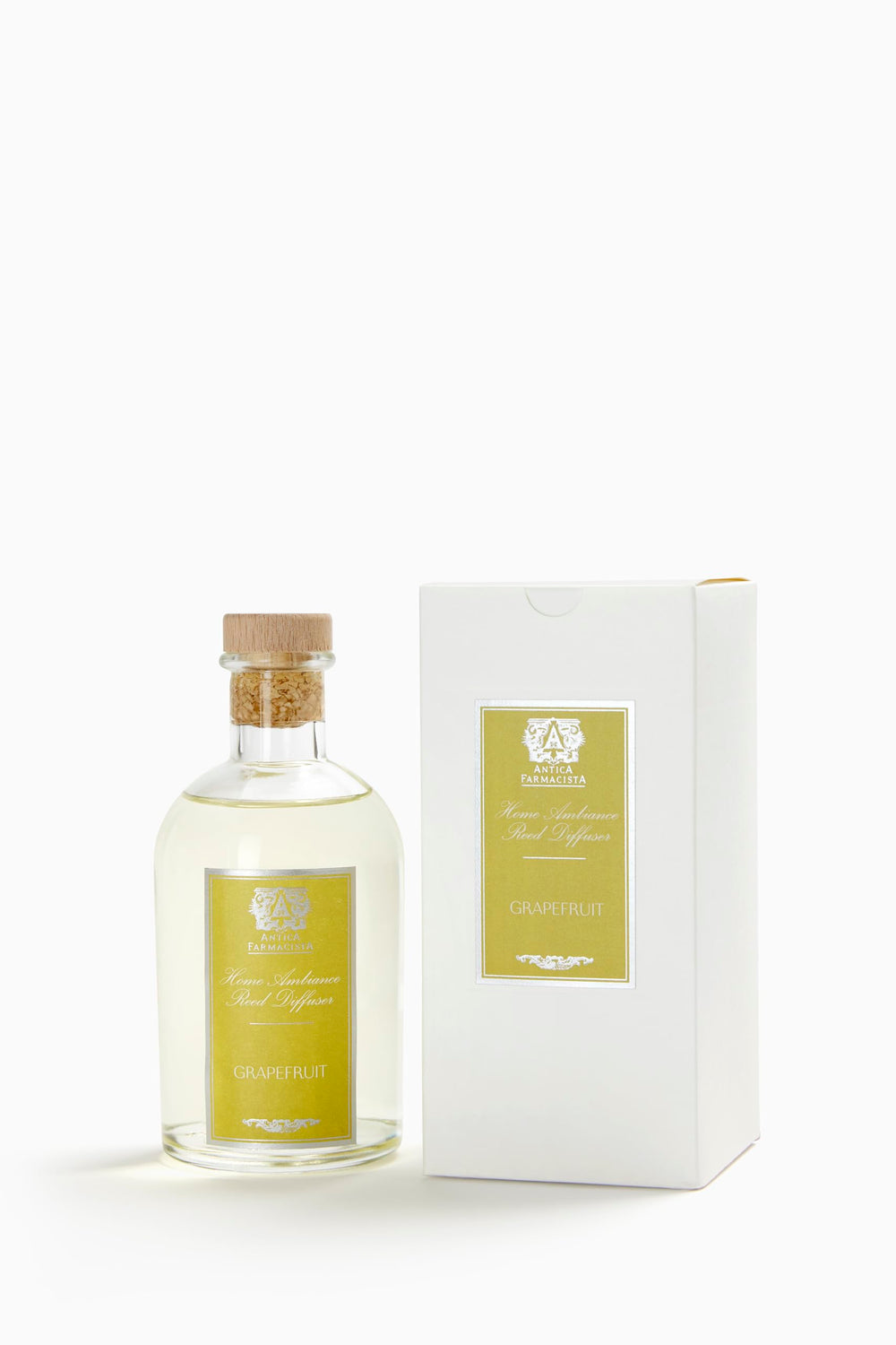 Close-up of Antica Farmacista Grapefruit diffuser bottle with reeds