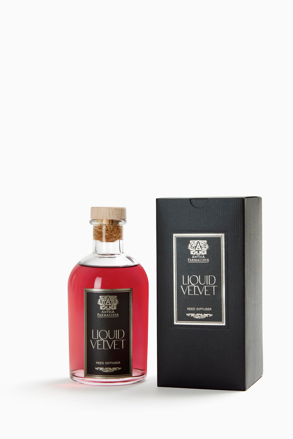Close-up of Antica Farmacista Liquid Velvet diffuser bottle with reeds