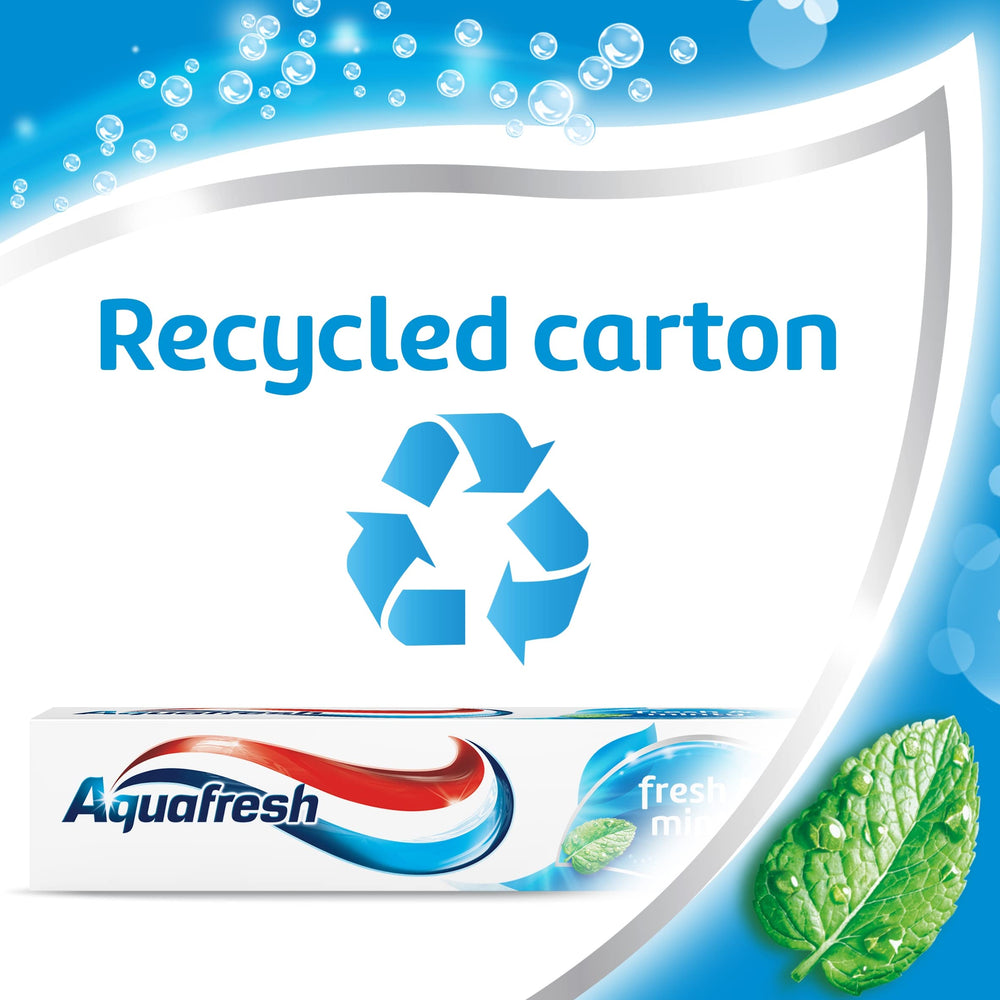 Aquafresh toothpaste beside a glass of water