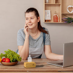 Aria glass essential oil diffuser showing premium wood base