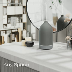 Close-up of handmade grey ceramic diffuser showing color-changing LEDs
