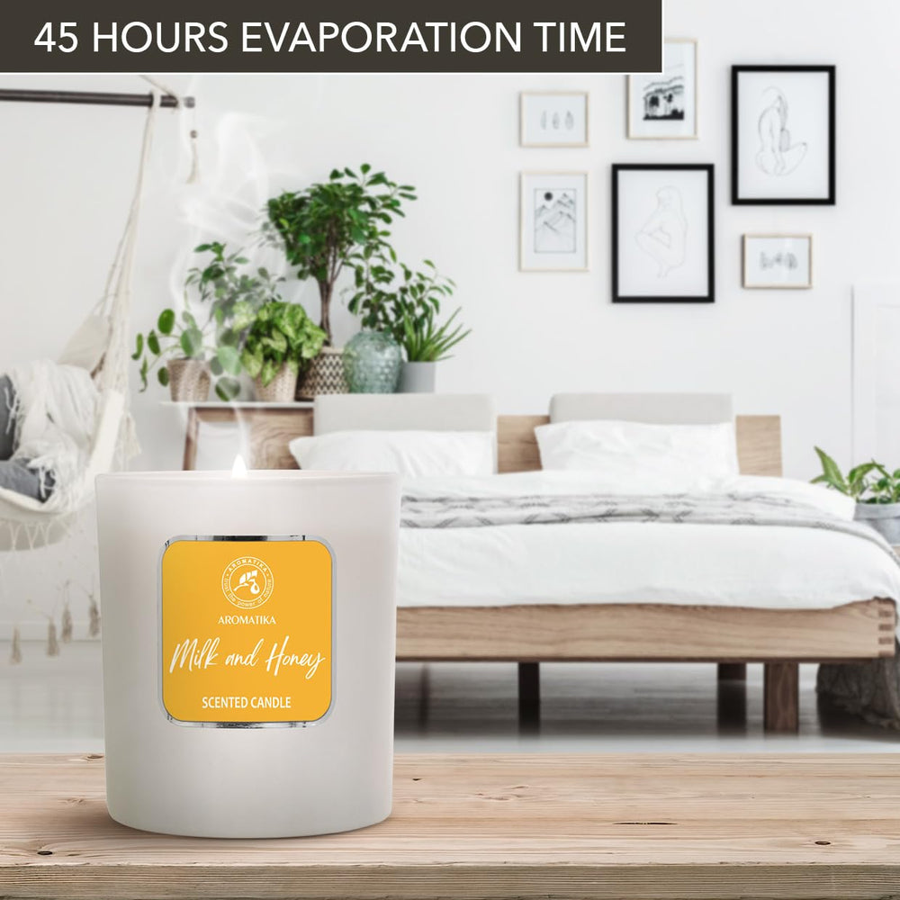 AROMATIKA Milk & Honey candle room ambient with soft glow.