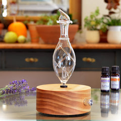 ArOmis Aromatherapy diffuser with hand-blown borosilicate glass reservoir and pine wood base