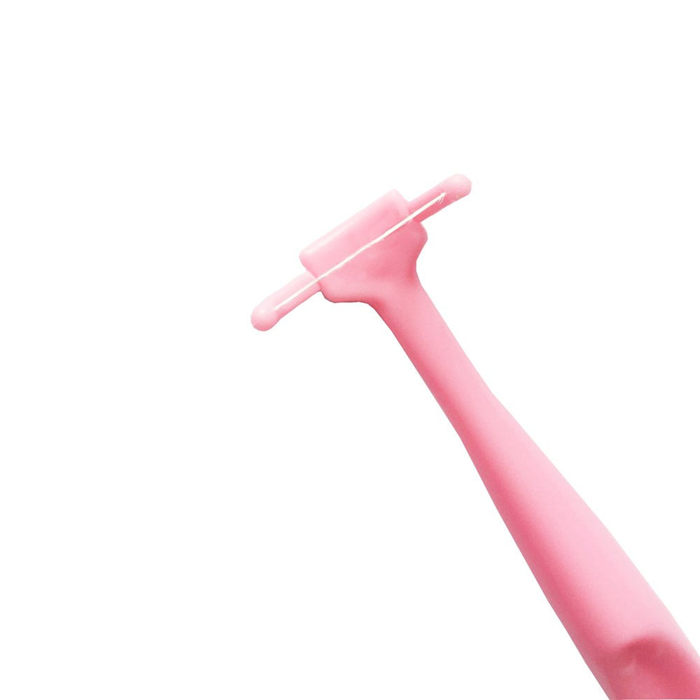 Close up of pink floss holder showing replaceable floss head