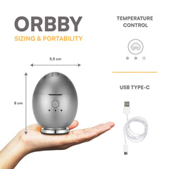 Artronic Orbby compact travel diffuser on a desk for on-the-go scent