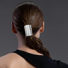 Aswewamt silver hair cuff on ponytail for a sleek finish.