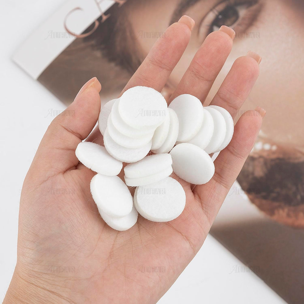 Close-up of white round mini diffuser refill pad (22mm) for diffuser jewelry