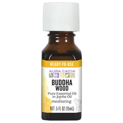 Aura Cacia Buddha Wood oil bottle closeup shows amber oil and purity.