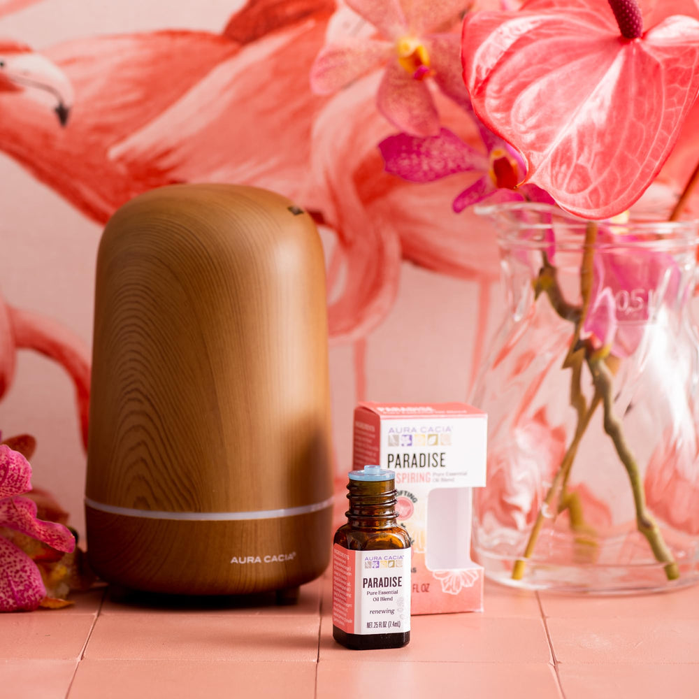 Aura Cacia Paradise essential oil blend with citrus, rose, jasmine notes.