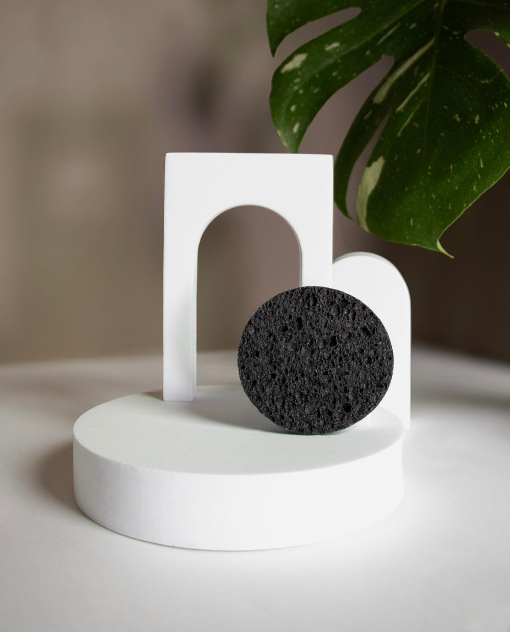 Bamboo Charcoal Cleansing Sponge in-use on face demonstrates mild cleansing and oil control.