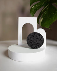 Bamboo Charcoal Cleansing Sponge in-use on face demonstrates mild cleansing and oil control.