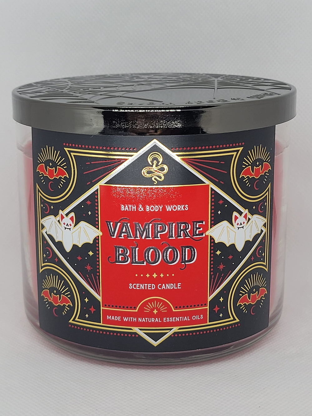 Close-up of glitter embellishment on Vampire Blood candle in red metal jar