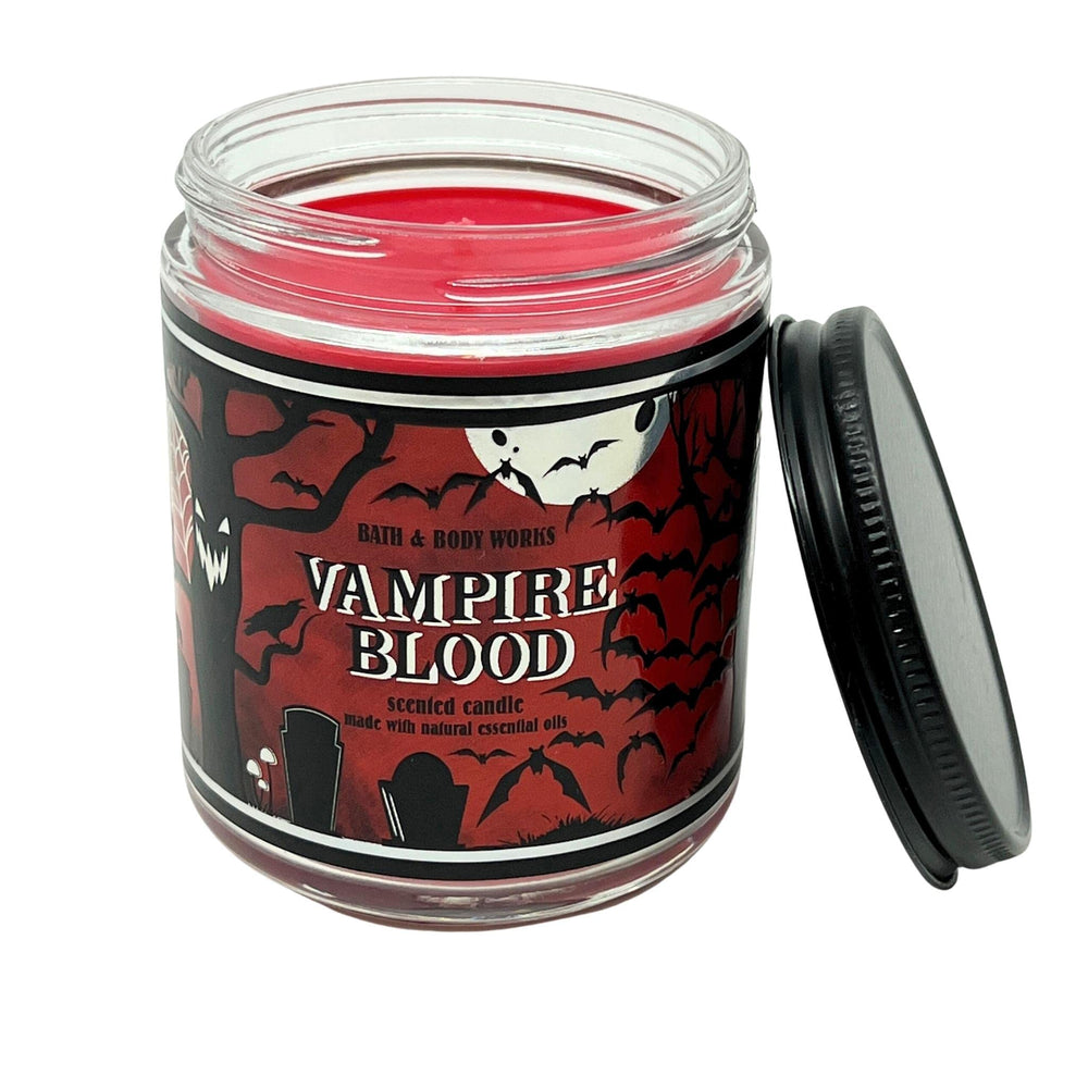 Close-up of red metal jar candle Vampire Blood scent