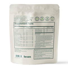 Happy child holding Beam Kids All-in-One Superfood Powder container