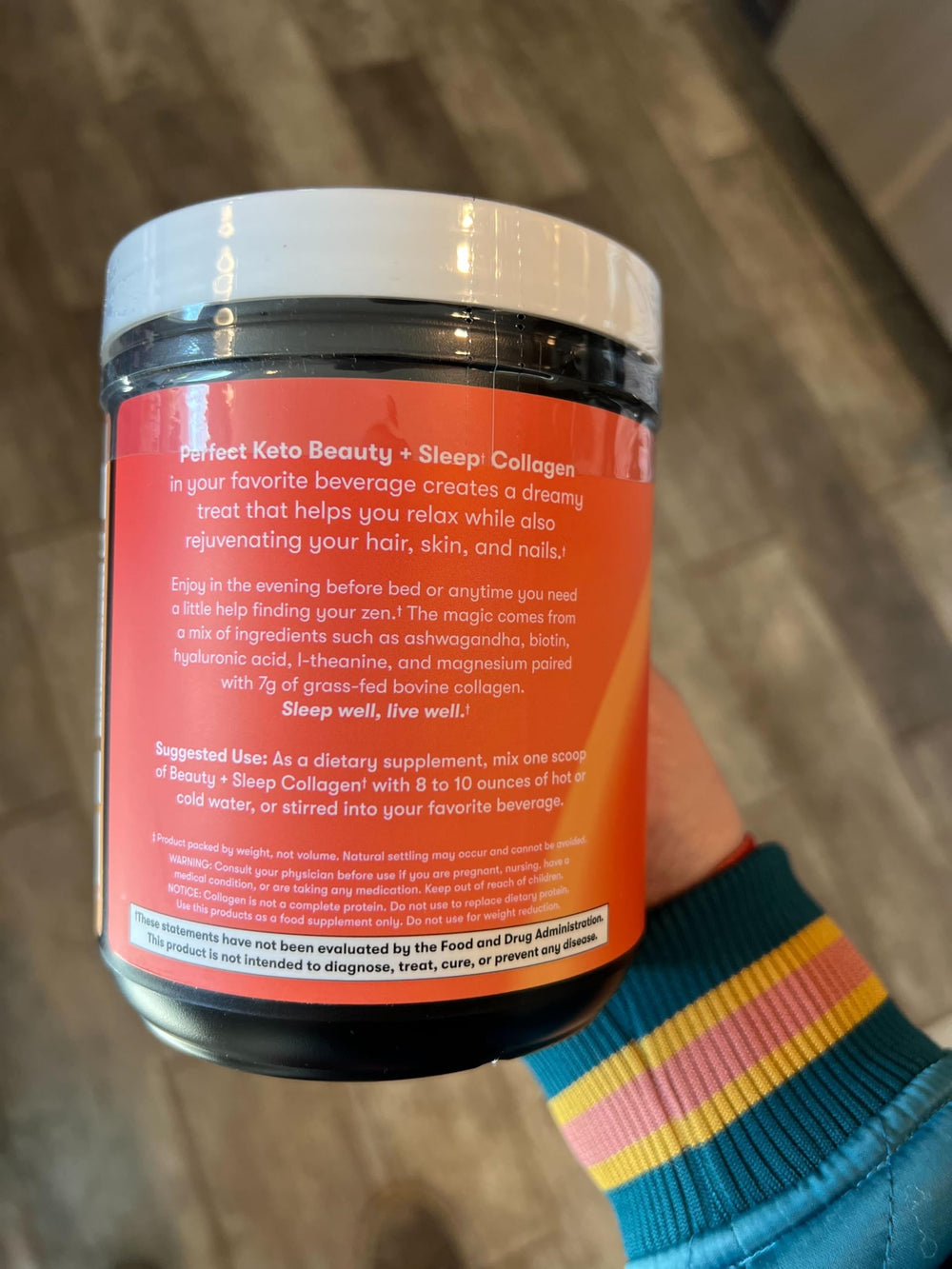 Scoop of Beauty + Sleep Collagen powder over a mug
