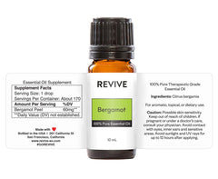 Close-up of bergamot essential oil bottle with citrus accents