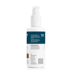 Chamomile flowers beside the lotion bottle