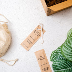 Individually wrapped floss picks in recyclable paper sleeves