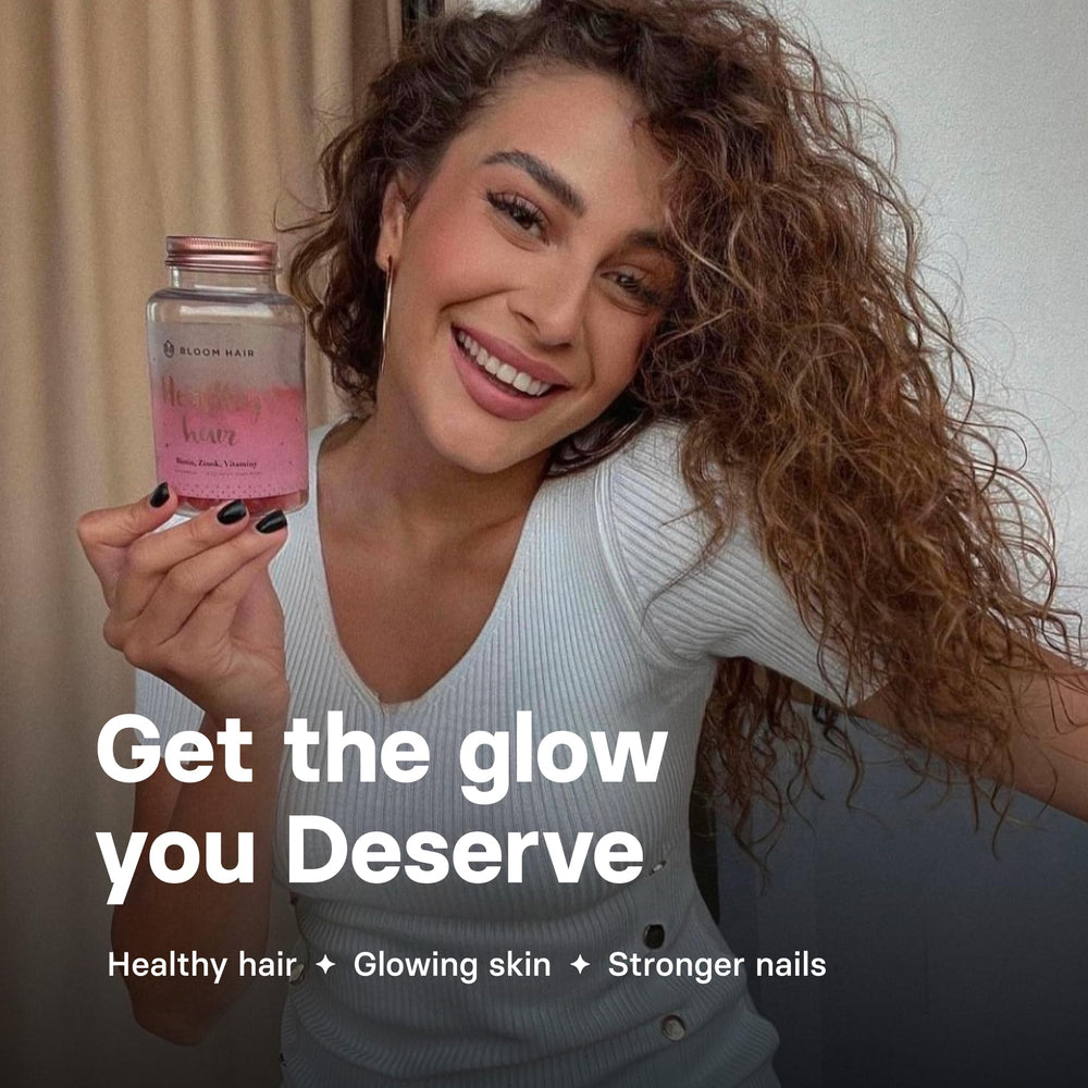 Lifestyle shot of a woman taking Bloom Hair Gummies