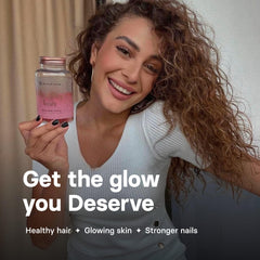 Lifestyle shot of a woman taking Bloom Hair Gummies