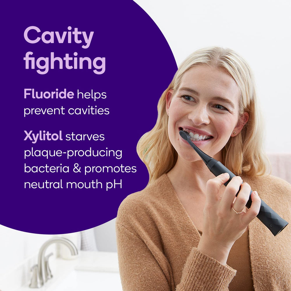 Close-up of BURST toothpaste tube highlighting fluoride and xylitol for cavity protection