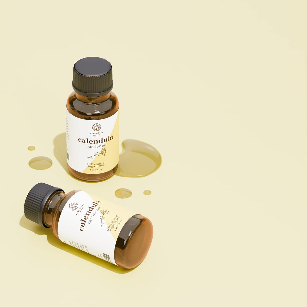 Dropper bottle of calendula oil on white background
