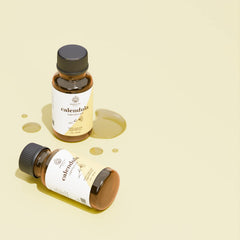 Dropper bottle of calendula oil on white background