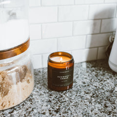 Amber jar candle with Cedar & Tobacco scent label