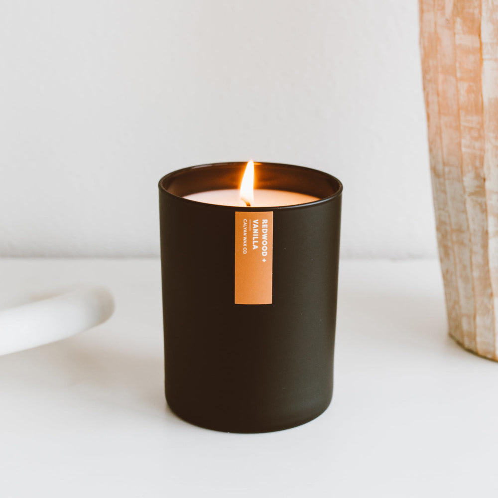 Matte black 10.2oz tumbler candle on wooden surface