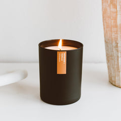 Matte black 10.2oz tumbler candle on wooden surface