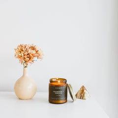Top view of amber jar with cotton wick and lid