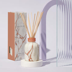 Reed diffuser sticks arranged in a sleek marble diffuser vase