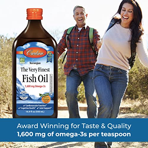 Orange flavor liquid fish oil being dispensed from a dropper