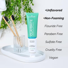 Squeezing ClayBrite toothpaste onto toothbrush