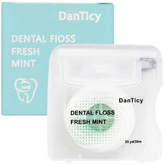 Close-up of mint coconut oil dental floss designed for wide spaces