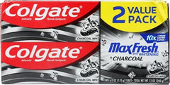 Open tube revealing charcoal-infused toothpaste paste