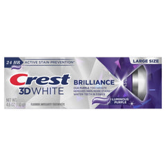 Toothbrush applying Crest 3D White Brilliance toothpaste to teeth