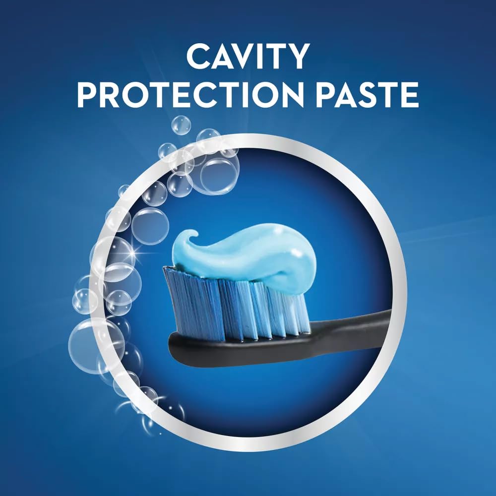 Crest toothpaste beside toothbrush and mint leaves