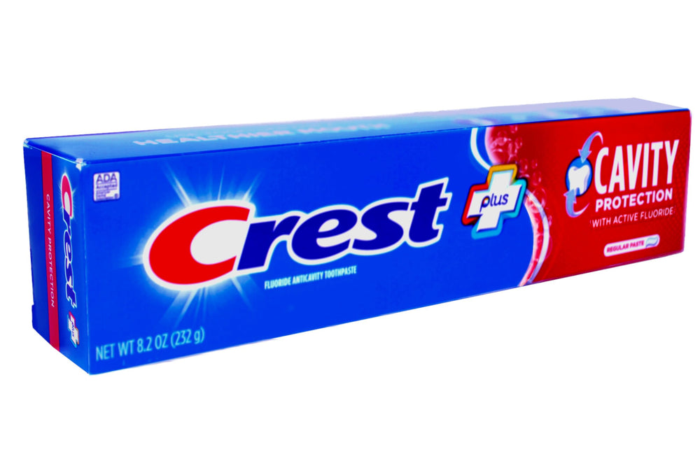 Close-up of Crest toothpaste being dispensed onto a toothbrush