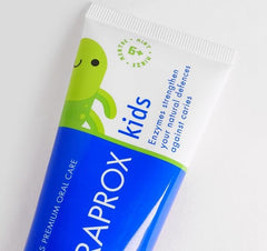 Child brushing teeth with Curaprox Kids toothpaste